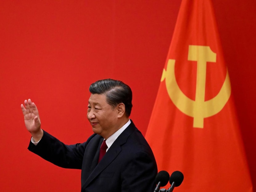 China's President Xi Jinping waves after introducing the members of the Chinese Communist Party's new Politburo Standing Committee, the nation's top decision-making body, in the Great Hall of the People in Beijing on Oct 23, 2022.
