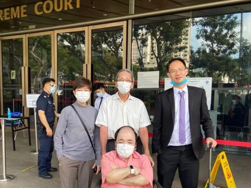 Four-time SEA Games taekwondo champion Wong Liang Ming (left) with her lawyer Clarence Lun (right) and her family outside the Supreme Court.