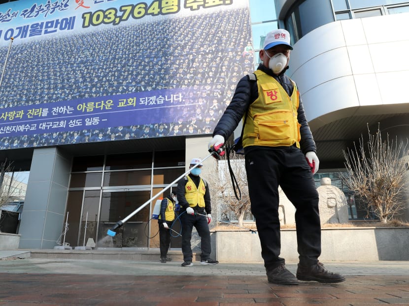 South Korean health officials spray disinfectant in front of the Daegu branch of the Shincheonji Church of Jesus in the southeastern city of Daegu on Feb 20, 2020. South Korean health officials spray disinfectant in front of the Daegu branch of the Shincheonji Church of Jesus in the southeastern city of Daegu on Feb 20, 2020.