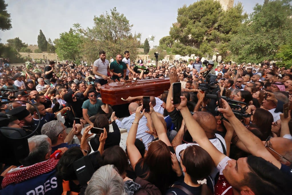 Mourners carry the coffin of slain veteran Al-Jazeera journalist Shireen Abu Akleh during her burial at the Mount Zion Cemetery outside Jerusalem's Old City on May 13, 2022, two days after she was killed while covering an Israeli army raid in the West Bank.
