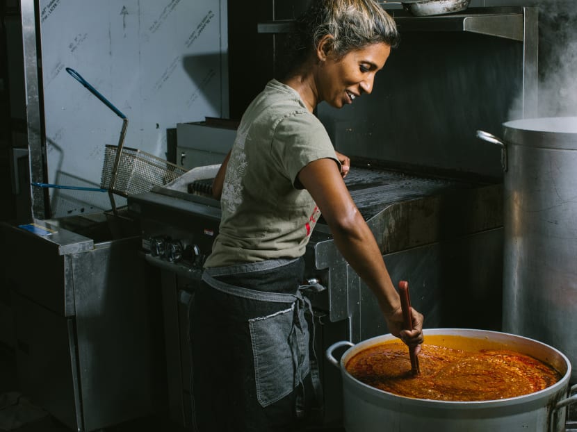 Ms Azalina Eusope stirs a pot of sambal, a spicy chile paste, in San Francisco, on July 23, 2018. There are more than 300 varieties of sambal, passed down through generations and over continents.