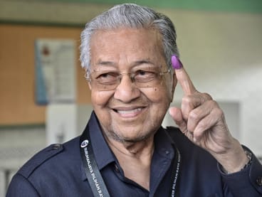 Former Malaysia Prime Minister Mahathir Mohamad showing his inked finger after casting his vote at a polling station during the general election in Kuala Kedah district on Nov 19, 2022.