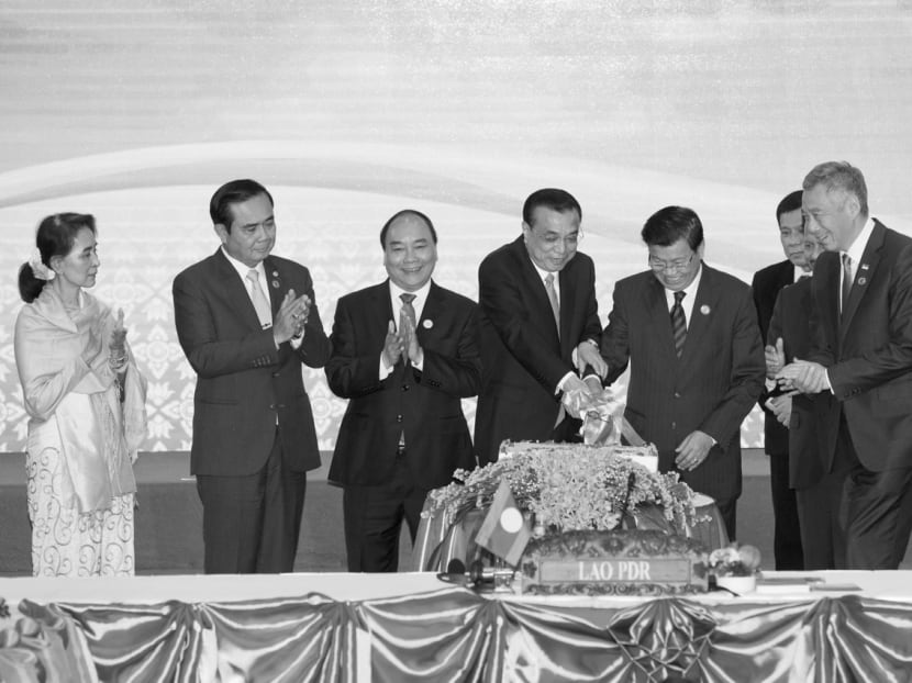 Asean leaders and Chinese Premier Li Keqiang (fourth from left) cutting a cake to mark the 19th Asean-China summit in Laos last Wednesday. While it is convenient to blame tensions in the South China Sea for straining Asean-China ties, there are multiple stress points in other facets of the relationship. Photo: AP