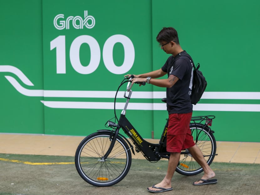 Full-time GrabFood delivery rider Nicholas Heng leaving GrabFood's e-Scooter Trade-In Grant (eTG) Centre with his new e-bike on Thursday (Jan 9).