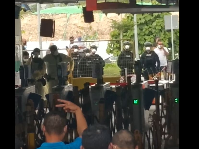 A screengrab of a video purportedly showing riot police deployed at Westlite Jalan Tukang dormitory on Oct 13, 2021.