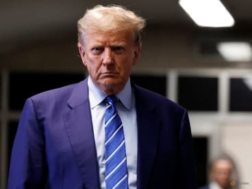 Former President Donald Trump listens to a question as he prepares to leave at the end second day of his criminal trial at NYS Supreme Court on April 16, 2024 in New York City.  