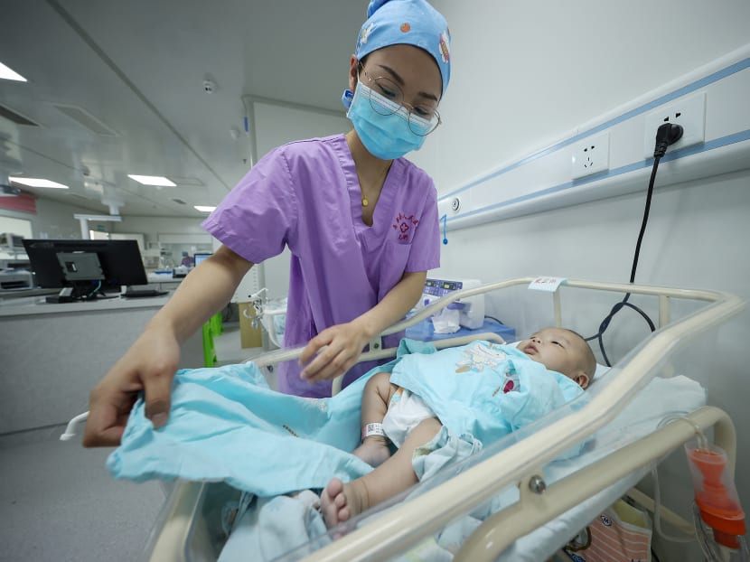 A medical staff member taking care of a newborn baby at a hospital in Danzhai, in China's southwestern Guizhou province, on May 11, 2021.