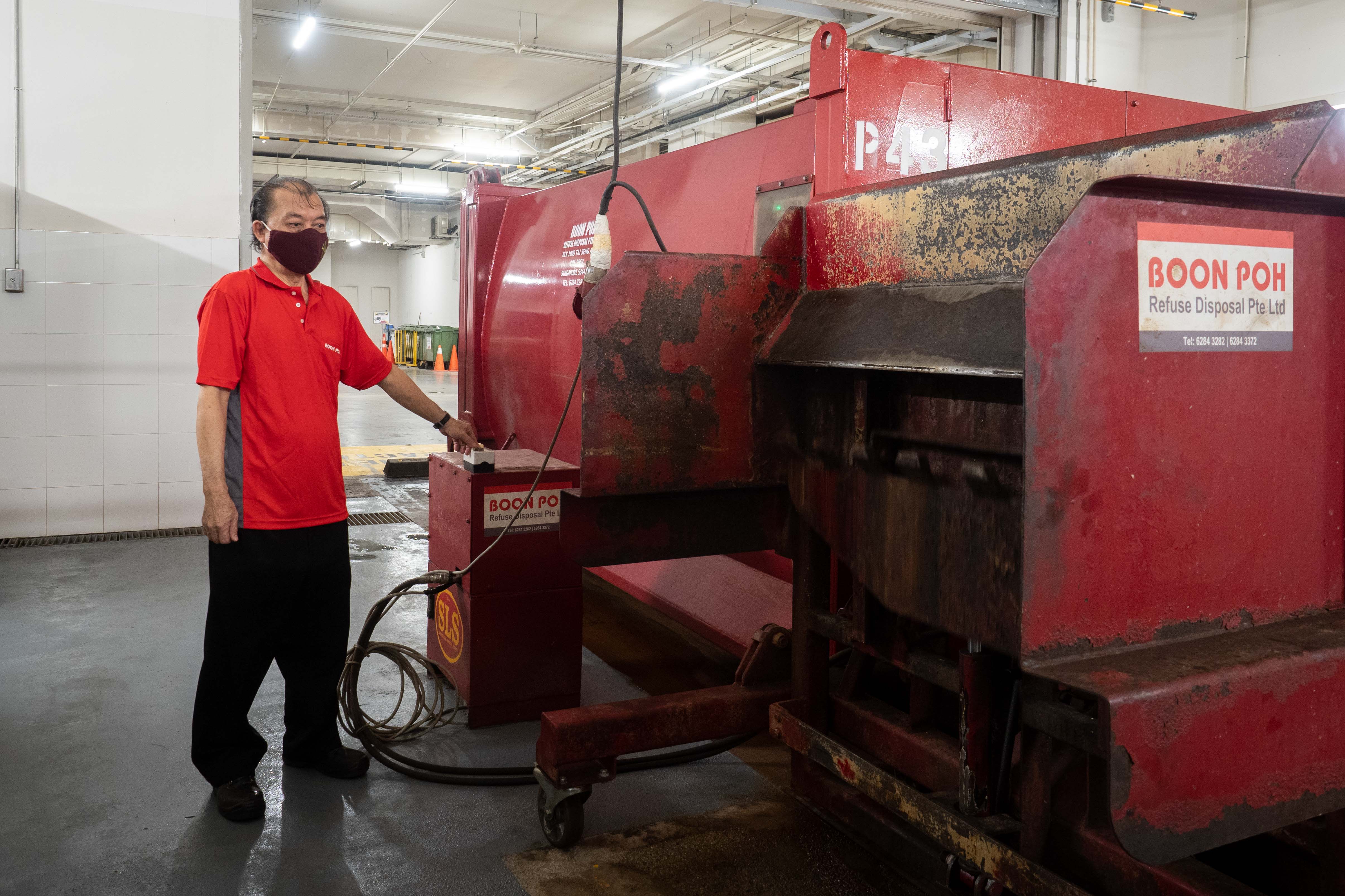 Waste sorter Yeo Hock Lye operating a trash compactor on Jan 24, 2022. Waste sorter Yeo Hock Lye operating a trash compactor on Jan 24, 2022.