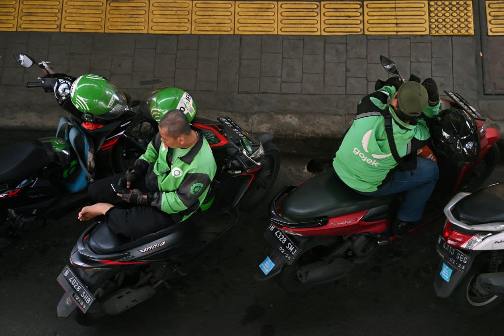 This file photo taken on April 11, 2022 shows Gojek motorcycle ride-hailing service riders waiting for customers in Jakarta. 