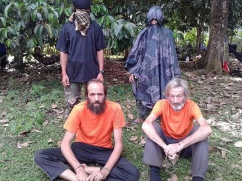 Hostages Canadian national Robert Hall (front right) and Norwegian national Kjartan Sekkingstad were taken hostage by the Qaeda-linked Abu Sayyaf Islamist militant group in the Philippines in 2015. REUTERS  file photo.