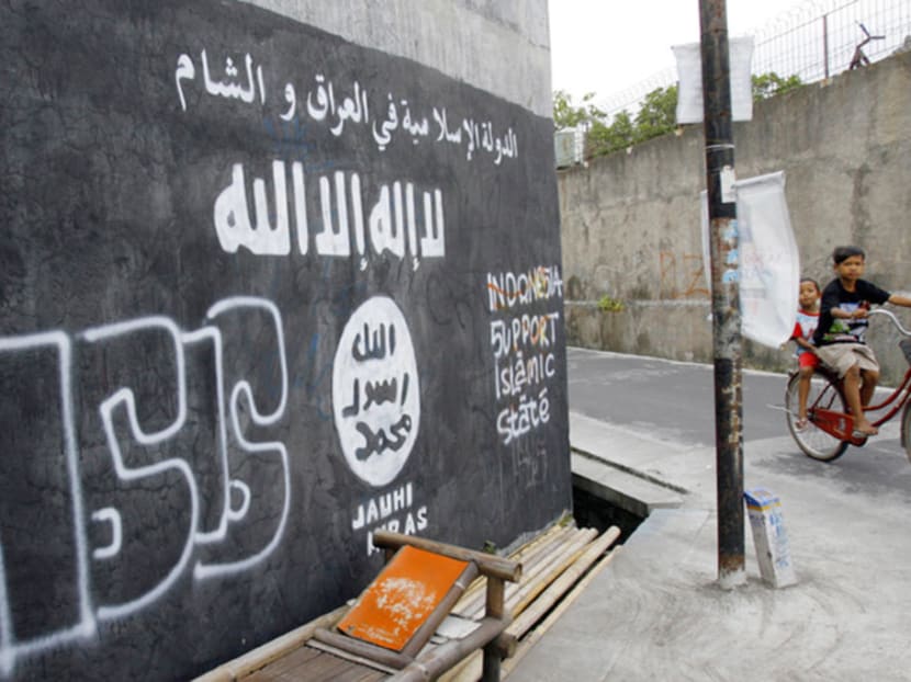 The Islamic State logo is depicted on a wall in Grogol, Central Java, in a file photo from 2014. The Islamic State logo is depicted on a wall in Grogol, Central Java, in a file photo from 2014.