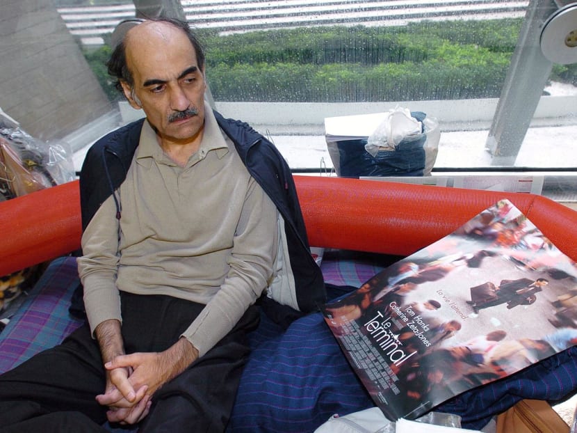 (FILES) In this file photo taken on Aug 12, 2004 Mehran Karimi Nasseri looks at a poster of the movie inspired by his life, in the terminal 1 of Paris Charles De Gaulle airport.
(FILES) In this file photo taken on Aug 12, 2004 Mehran Karimi Nasseri looks at a poster of the movie inspired by his life, in the terminal 1 of Paris Charles De Gaulle airport.