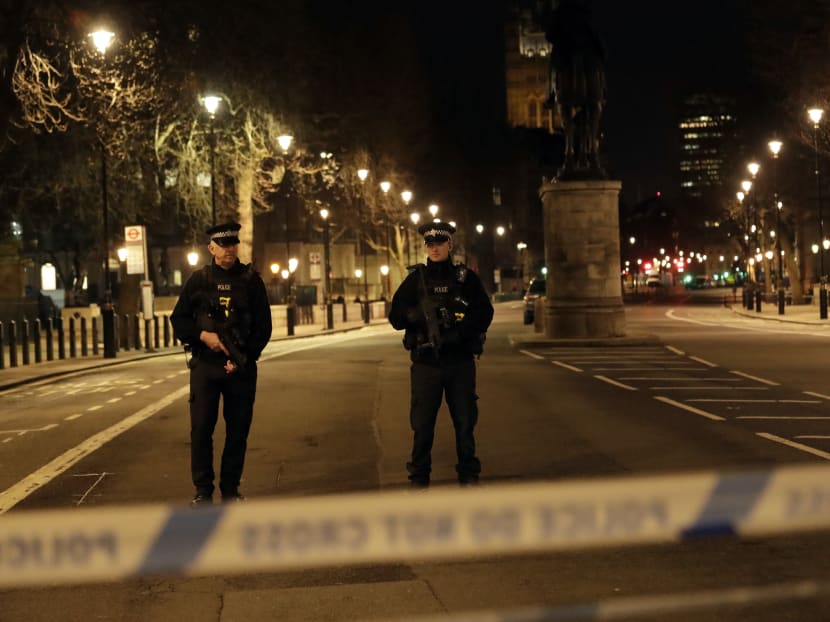 Two policemen stand guard at a cordoned off area on the way to the Houses of Parliament in central London, Wednesday, March 22, 2017. Photo: AP