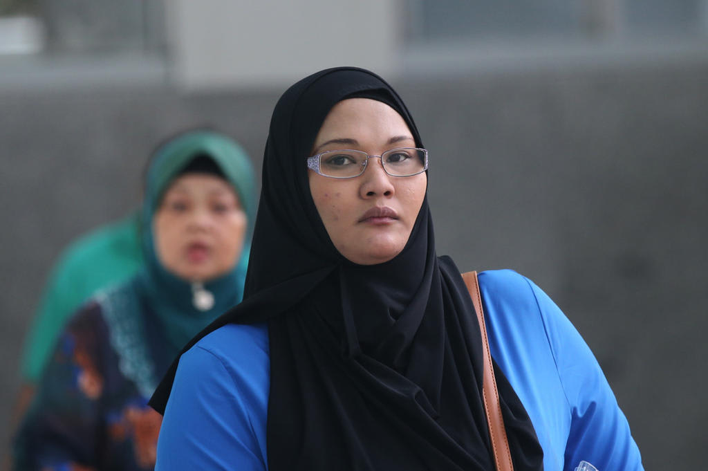 Registered nurse Sa'adiah Jamari (pictured in foreground) is contesting two counts of administering poisons to a five-month-old baby and an 11-month-old child in 2016 in separate cases. Registered nurse Sa'adiah Jamari (pictured in foreground) is contesting two counts of administering poisons to a five-month-old baby and an 11-month-old child in 2016 in separate cases.