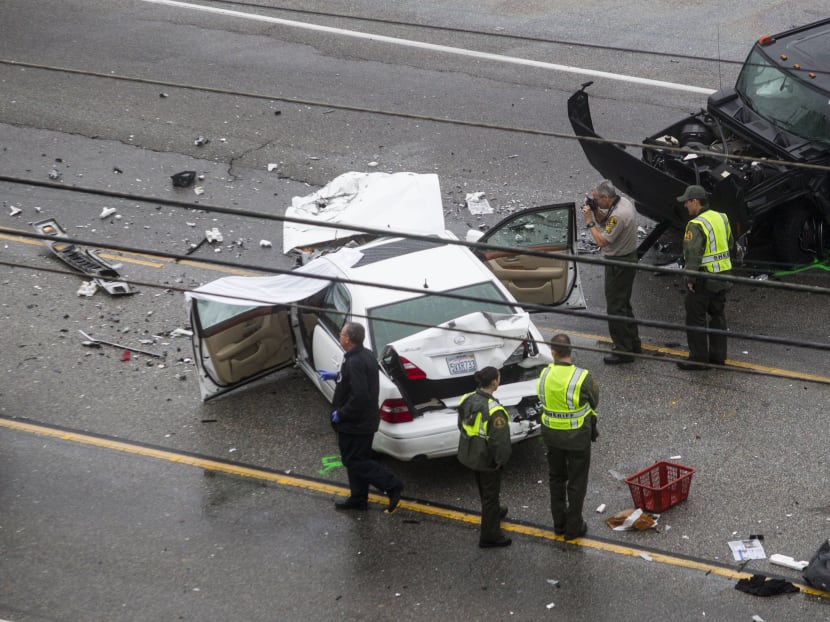 Los Angeles County Sheriff's deputies investigate the scene of a car crash where one person was killed and at least seven other's were injured, Saturday, Feb. 7, 2015. Olympic gold medalist Bruce Jenner was in one of the cars involved in the four-vehicle crash on the Pacific Coast Highway in Malibu, Calif., that killed a woman, Los Angeles County authorities said. Photo: AP