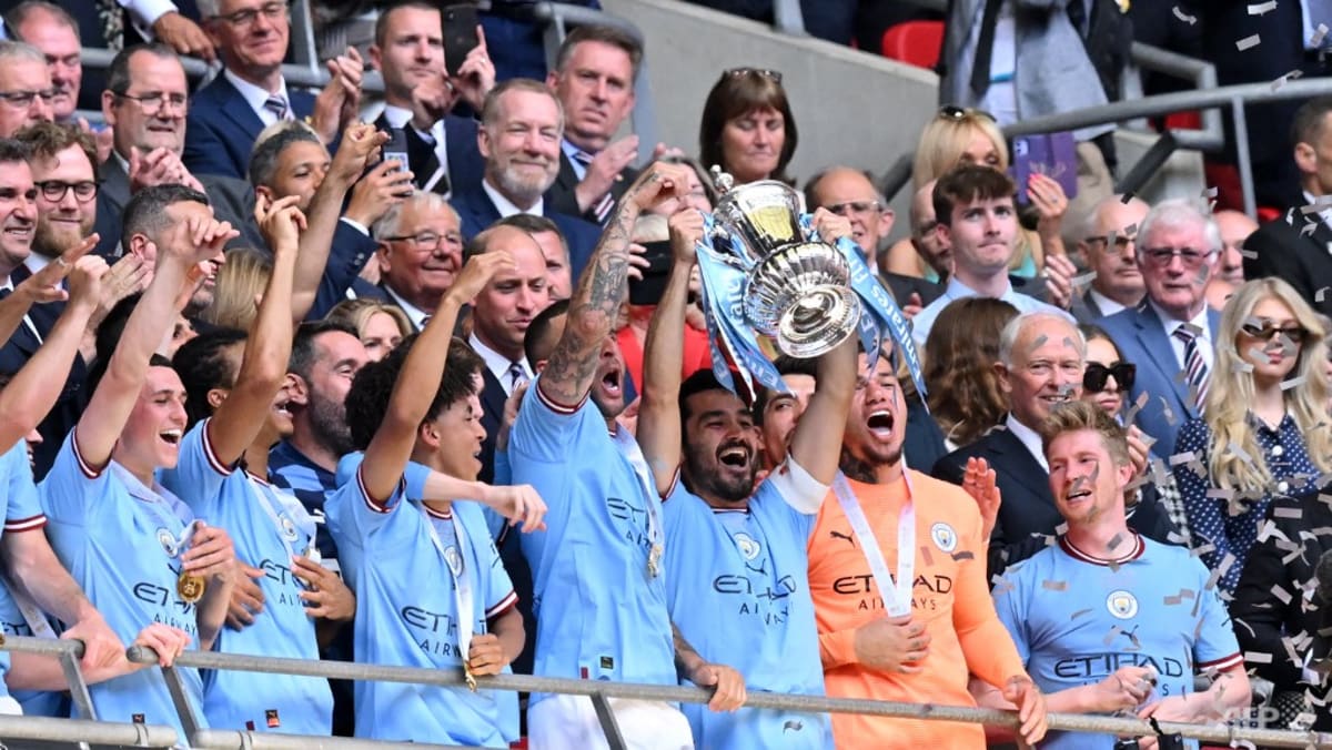 Manchester City's Erling Haaland holds the winners trophy as he celebrates  winning the English FA Cup final soccer match between Manchester City and  Manchester United at Wembley Stadium in London, Saturday, June
