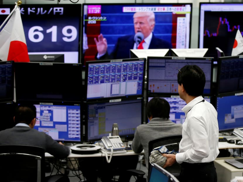 Employees of a foreign exchange trading company in Tokyo. Photo: Reuters file photo