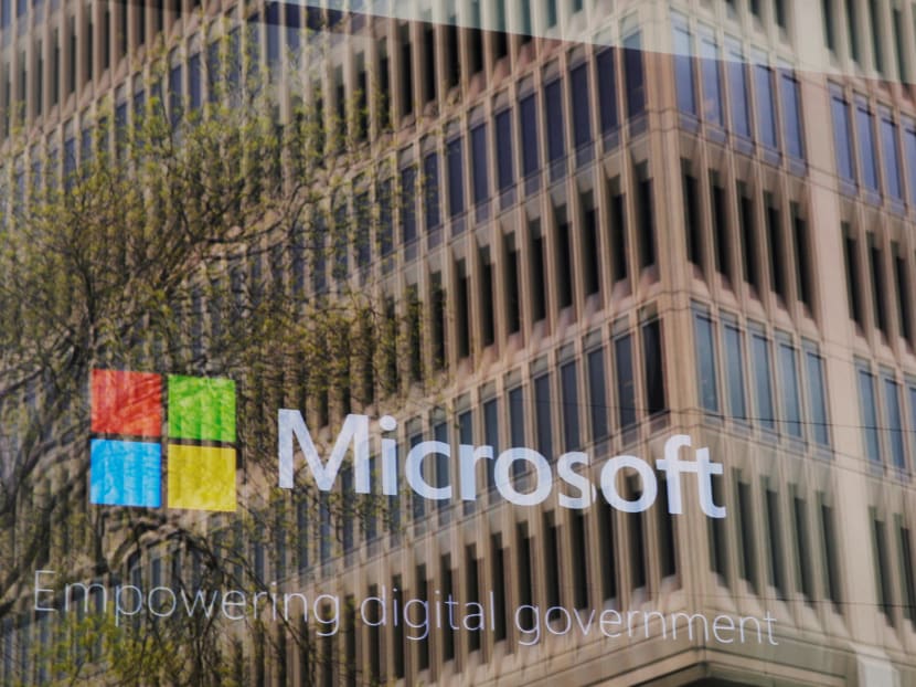 An promotional video plays behind a window reflecting a nearby building at the Microsoft office in Cambridge, Massachusetts, U.S. May 15, 2017. Photo: Reuters