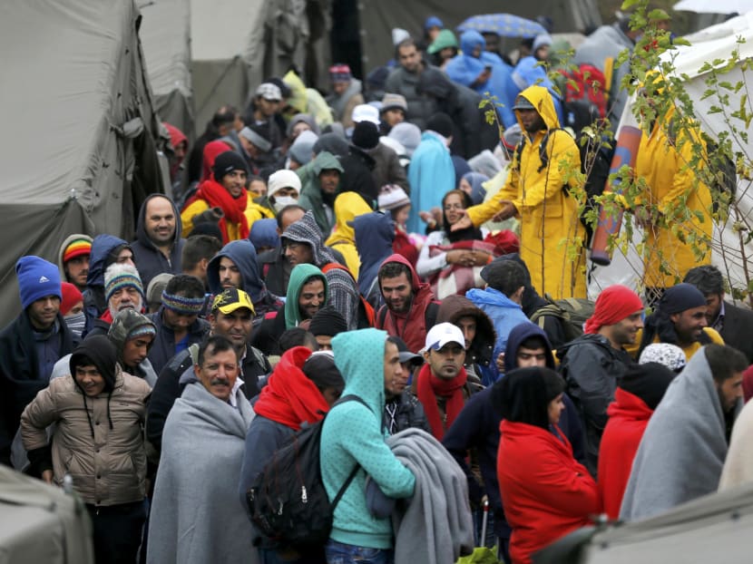 Migrants wait to board a bus at a refugee camp in Croatia. Photo: Reuters