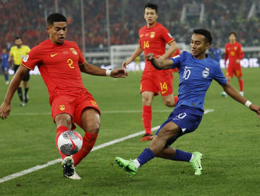 Singapore's Faris Ramli (in blue) in action with China's Jiang Guangtai during the 2026 FIFA World Cup qualifier at the Tianjin Olympic Center, Tianjin, China on March 26, 2024.