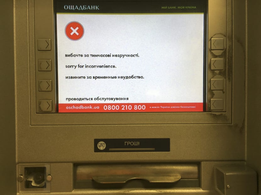 A screen of an idle virus affected cash machine in a state-run OshchadBank says "Sorry for inconvenience/Under repair" in Kiev, Ukraine. Photo: AP
