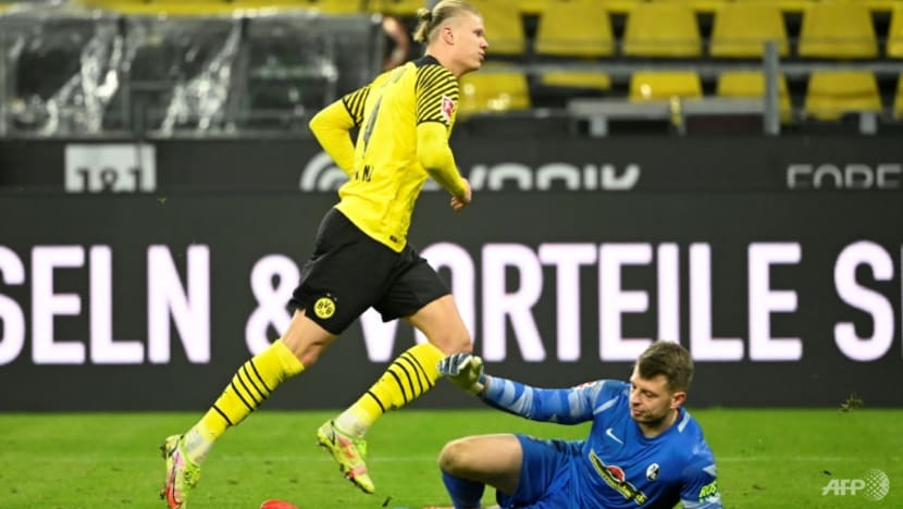 Haaland double sees Dortmund rout Freiburg to trim Bayern's lead Haaland double sees Dortmund rout Freiburg to trim Bayern's lead
