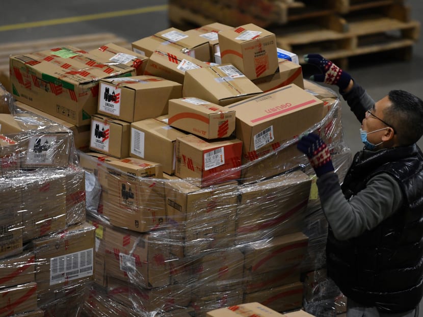 A worker sorts packages for delivery at a JD.com warehouse during the Singles' Day shopping festival in Beijing on Nov 11, 2020.
