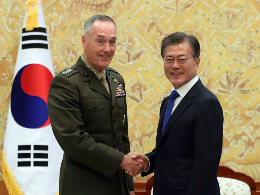 US Chairman of the Joint Chiefs of Staff General Joseph Dunford (left) with South Korean President Moon Jae-in during their meeting at the Presidential Blue House in Seoul, South Korea, on Aug 14.  General Joseph Dunford, reaffirmed the US’ commitment to protect South Korea after a meeting with Mr Moon, spokesman Park Su-hyun told reporters. Photo: Reuters