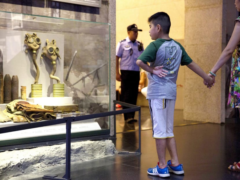A child looking at an exhibit on the chemical warfare used by Japanese forces in the Memorial Museum of Chinese People’s War of Resistance against Japanese Aggression in Beijing on Saturday. Patriotic education is mandated in Chinese schools, and students often go on field trips to sites highlighting atrocities of the Japanese invaders. Photo: AP