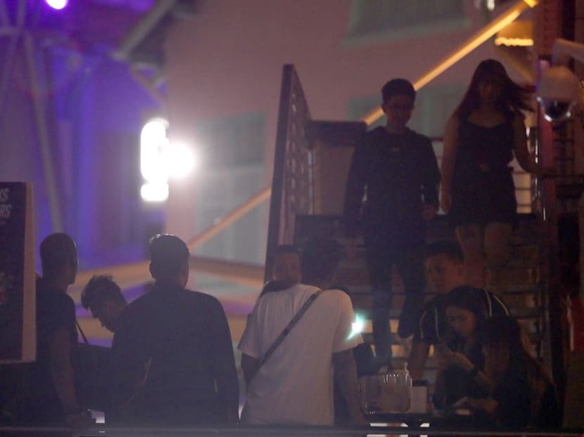 Partygoers outside Get Juiced, a club at Clarke Quay, on March 25, 2020.