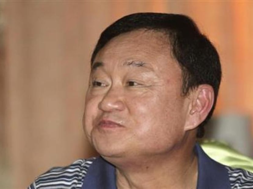 Former Thai prime minister Thaksin Shinawatra smiles to his supporters at a hotel in Cambodia, April 14, 2012. Photo: Reuters