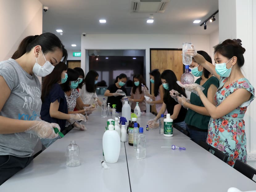 Some of the "super mummies" from Teck Ghee Parkview HDB estate in Ang Mo Kio hand making sanitisers for lifts in the blocks.