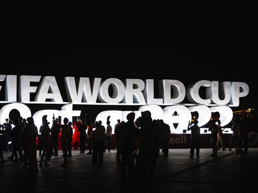 People gather in front of a Fifa World Cup sign in Doha on Nov 16, 2022, ahead of the Qatar 2022 World Cup football tournament.