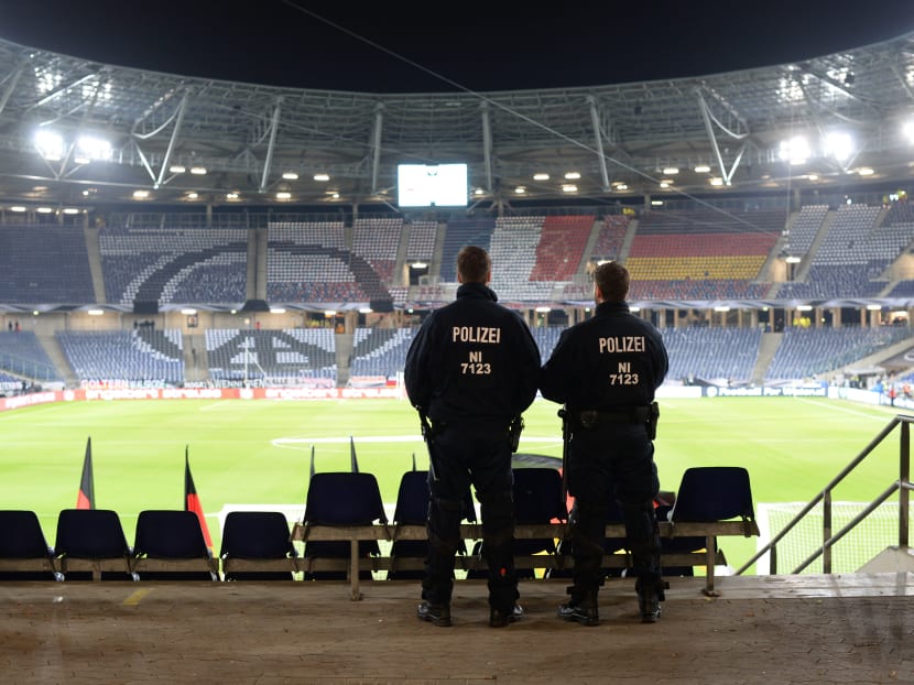Two police officers stand in the HDI-Arena in Hannover, Germany, Tuesday, Nov. 17, 2015 just before the stadium was evacuated before the friendly soccer match between Germany and the Netherlands. Photo: AP