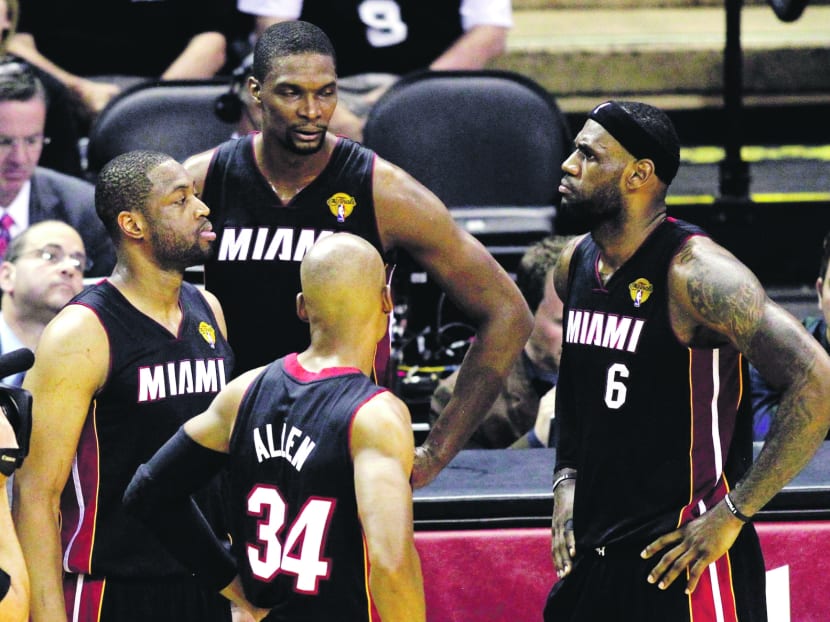 (From left) Miami Heat players Dwyane Wade, Chris Bosh and LeBron James. The futures of the ‘Big 3’ remain uncertain as 
the team heads home without a championship parade. 
PHOTO: REUTERS