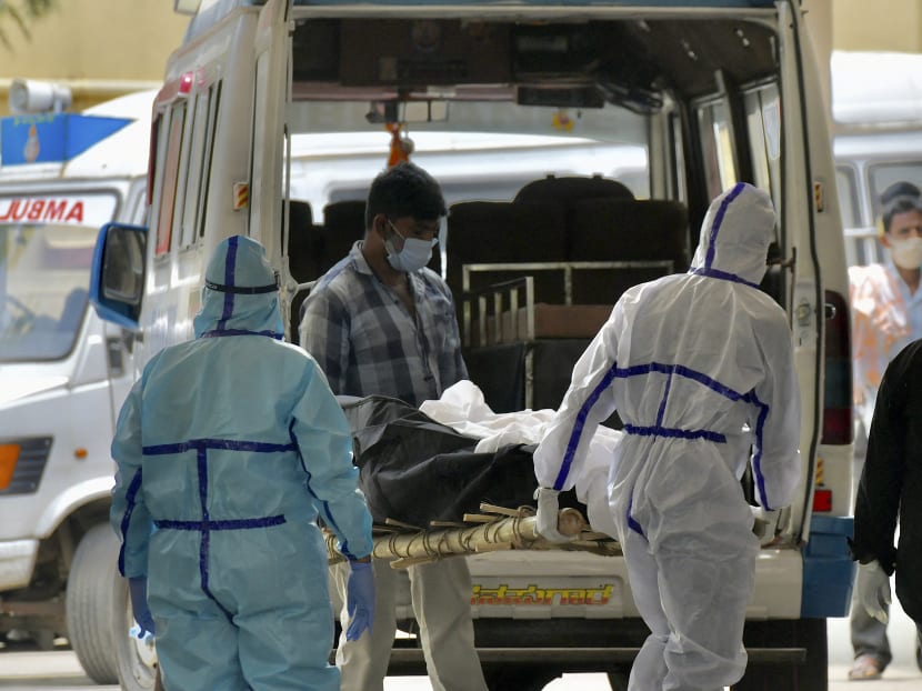 Family members, with help from the municipal staff members, transfer the bodies of the patients who died of Covid-19 from the ambulance at a crematorium in Bangalore, India on April 15, 2021. Family members, with help from the municipal staff members, transfer the bodies of the patients who died of Covid-19 from the ambulance at a crematorium in Bangalore, India on April 15, 2021.