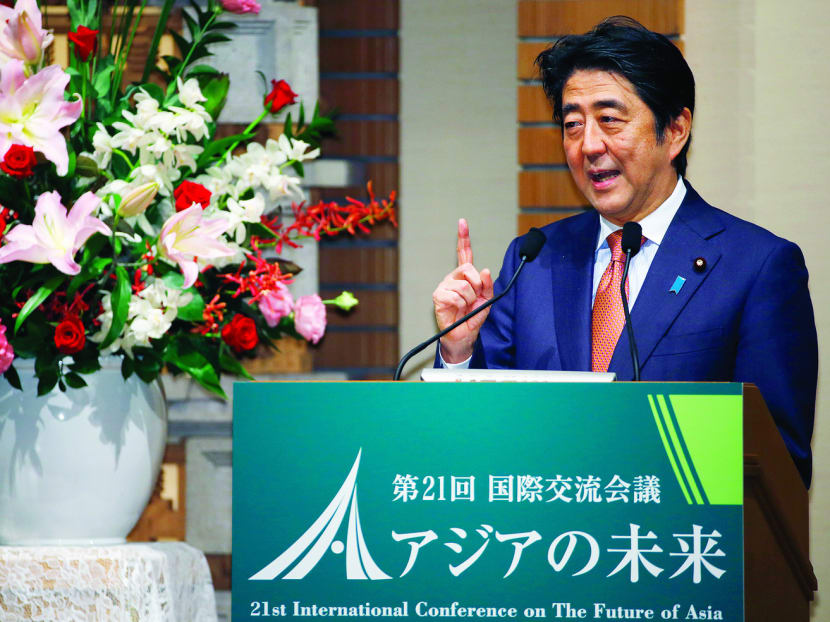 Japanese Prime Minister Shinzo Abe speaks during a banquet of a symposium on the “Future of Asia” in Tokyo, Thursday, May 21, 2015.  Vying to keep pace with China’s rising influence and economic clout, Japan plans to provide $110 billion to help develop roads, ports and other infrastructure in Asia in the next five years, Prime Minister Abe said Thursday. (AP Photo/Shizuo Kambayashi)