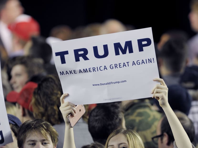 Donald Trump supporters hold up signs during a rally. Photo: AP