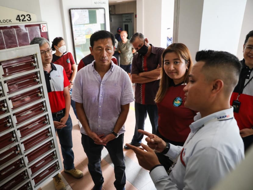Ms Nadia Ahmad Samdin, MP for Ang Mo Kio GRC, and Minister for Health Ong Ye Kung speak to a SingPost postman who is trained to monitor letterboxes for irregularities in mail collection patterns of the residents in Cheng San precinct on Jan 8, 2023.