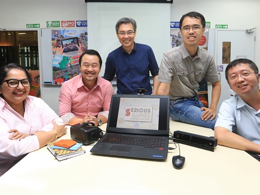 Members of the Serious Games Association: Neeru Bahl, Koo Seng Meng, Ivan Boo, Fredrik Lee,  Loh Yong Joo, posing with game gadgets on April 1, 2016. Photo: Koh Mui Fong/TODAY