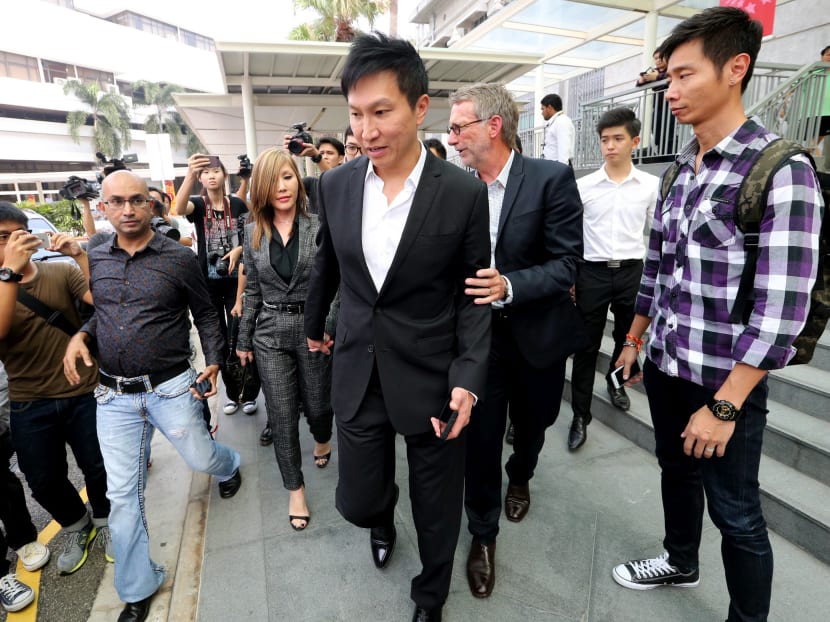 Kong Hee (centre) and his wife Sun Ho leaving the State Courts today after the verdict. Photo: Ooi Boon Keong/TODAY