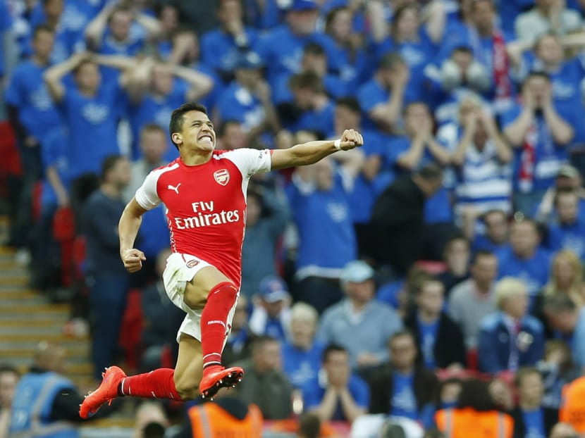 Arsenal's Alexis Sanchez celebrates after scoring his sides second goal during the English FA Cup semi-final soccer match between Arsenal and Reading at Wembley stadium in London last Saturday (April 18). Photo: AP