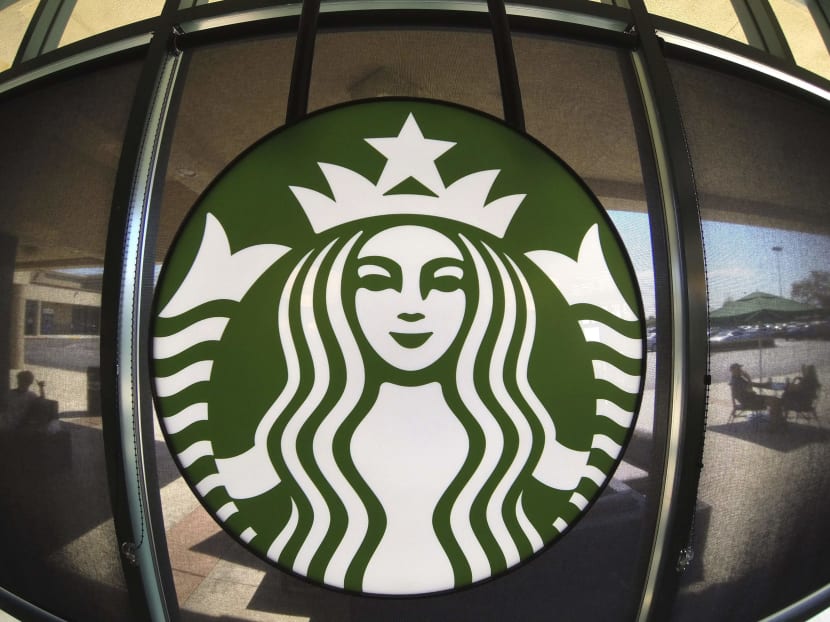 The Starbucks logo hangs on a window inside a newly designed Starbucks coffee shop in Fountain Valley, California on Aug 22, 2013. Photo: Reuters