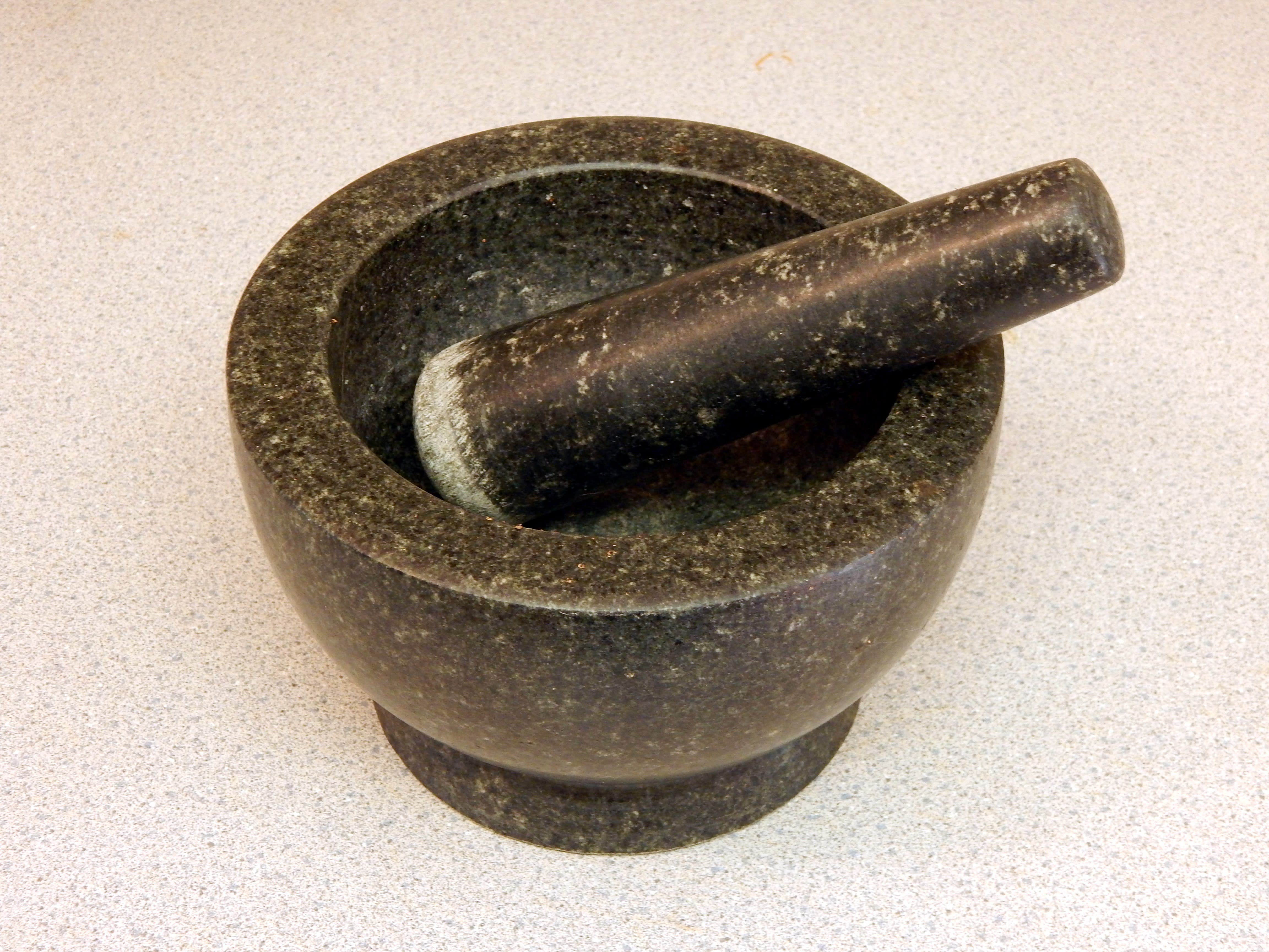 A picture of a mortar and pestle. Moni Lal Chan used a stone pestle to hit his dormitory mate after an argument.
