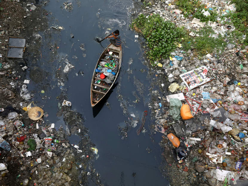 Photo of the day: A man on a boat collects plastic materials from dirty water in Dhaka, Bangladesh, on April 17, 2019.
