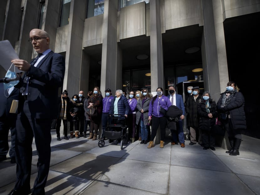Victims, as well as family and friends of victims of the 2018 deadly van attack gather outside the Toronto Courthouse in Toronto, Ontario, as crown attorney Joe Callaghan reads a statement to media following the verdict in the trial of accused van attacker Alek Minassian on March 3, 2021.