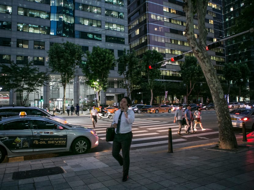 A worker leaving his office in Seoul. President Moon has pushed policies to improve working conditions and increase wages in the hope that rising consumption will trigger a virtuous cycle of employment and growth.