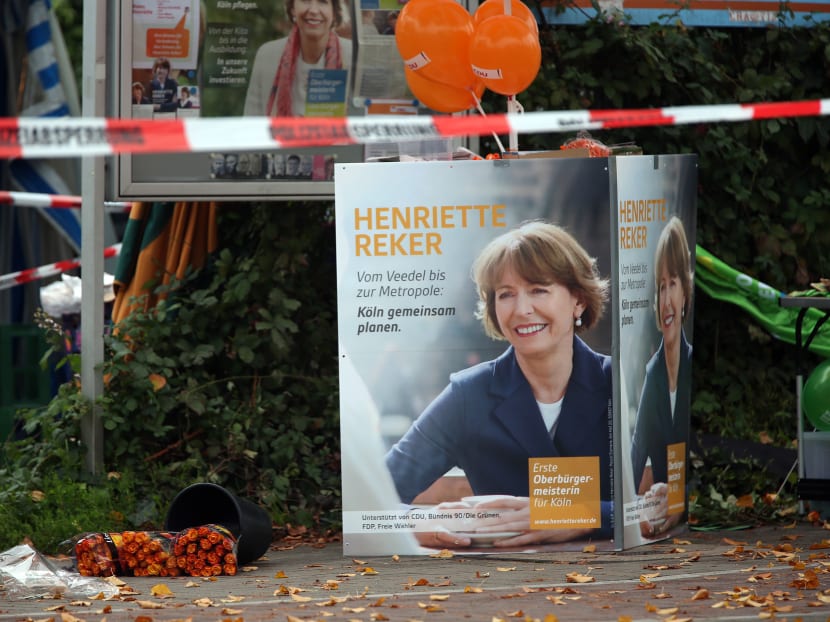 Election posters of independent candidate for the mayor of Cologne Henriette Reker behind a police barrier in Cologne, Germany, Saturday, Oct 17, 2015. Reker was wounded in a stabbing at this site as she campaigned. Photo: AP