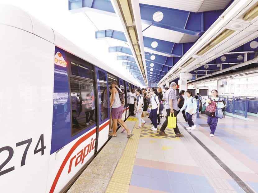 Malaysian commuters board the MRT in Kuala Lumpur. Prime Minister Najib Razak says the country's public transport network languished for decades due to “one man’s” obsession with developing a national car. Photo: Malay Mail Online