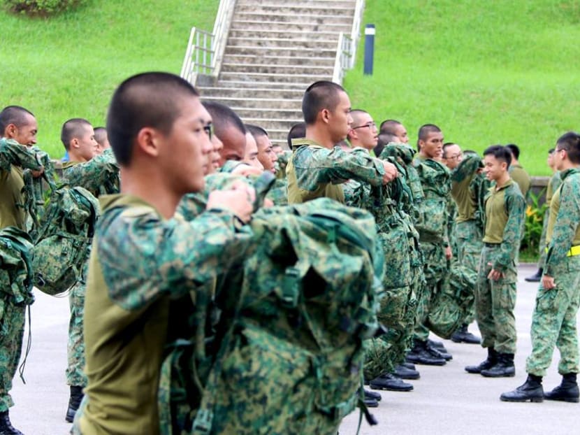 Singapore Armed Forces personnel carrying out a combat physical training exercise in their hybrid uniform.